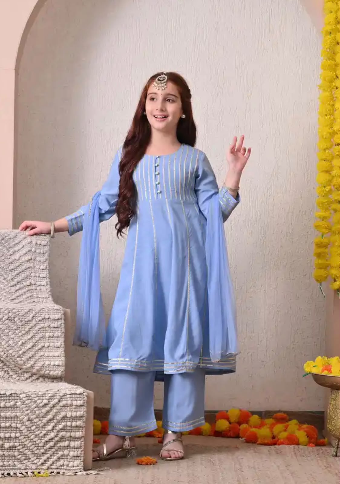Girl in a sky-blue kurti with trousers and dupatta